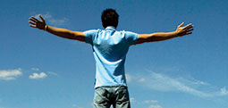 Male student with arms spread wide open