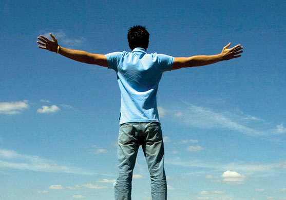 Male student with arms spread wide open