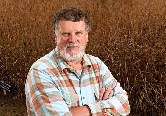 Edzard van Santen standing in a field of switchgrass