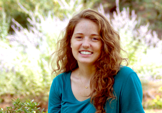 College of Agriculture student, Emily Brennan, sitting outside in a garden.