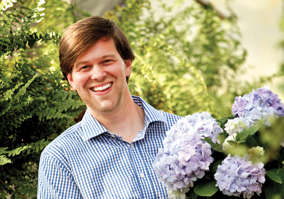 College of Agriculture alumnus, James T. Farmer III holds a bucket of blue hydrangeas.