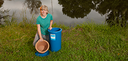 Mollie Smith displays a low-cost ceramic water purifier designed to filter contaminants from water so that it can be used for drinking.