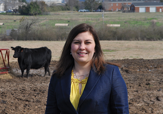 image of Christy Bratcher standing in a pasture
